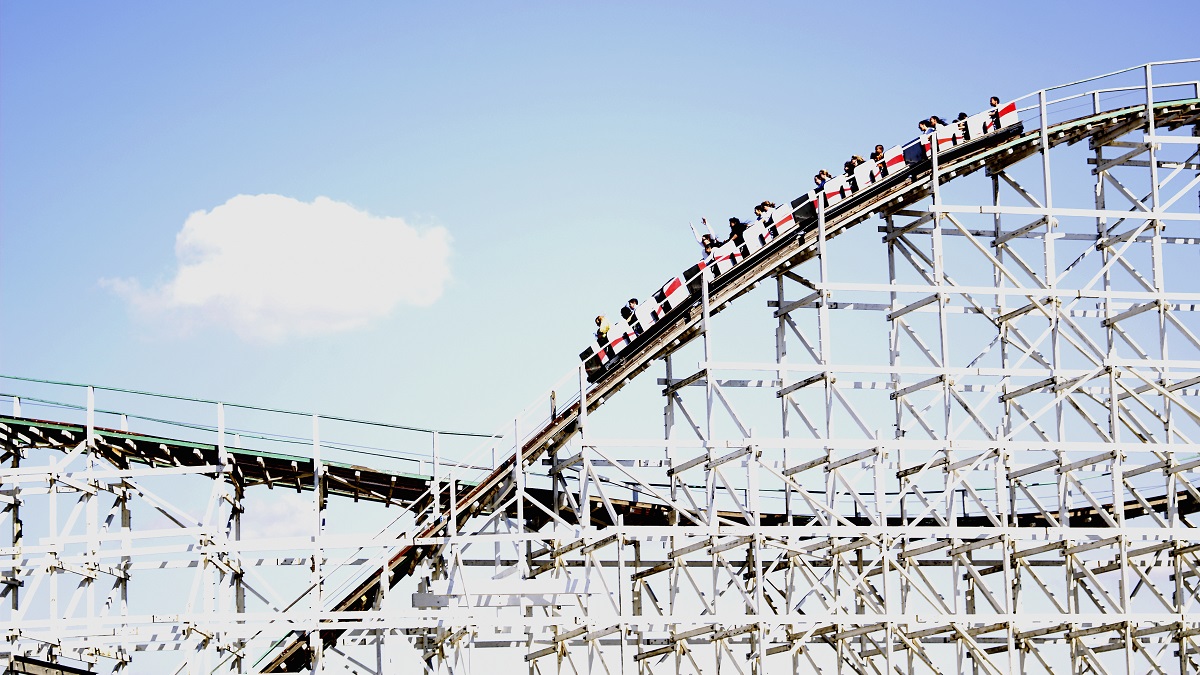 People riding rollercoaster, side view