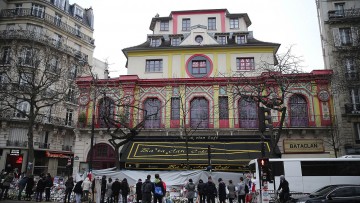 People laying flowers outside the Bataclan concert hall in December 2015, a month after the Paris terror attacks
