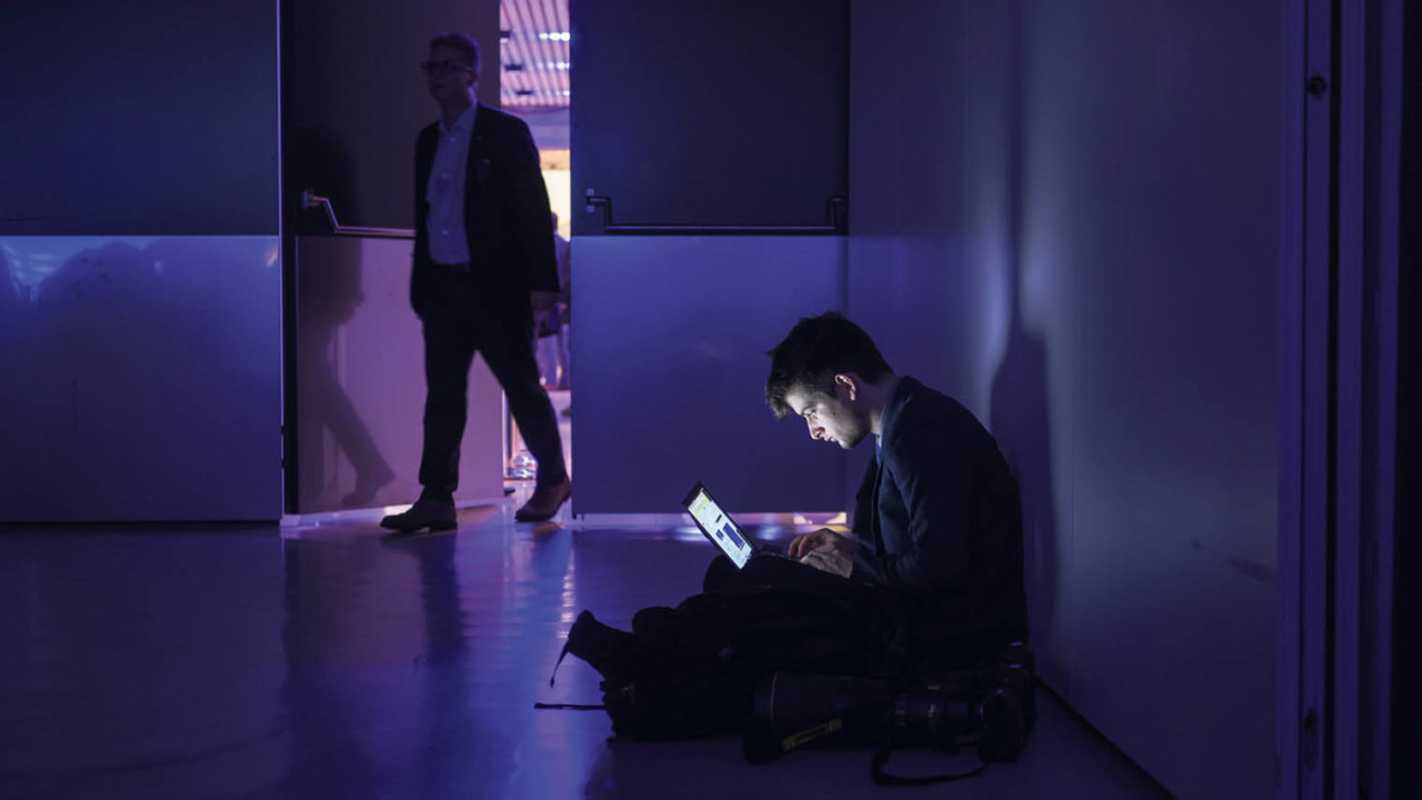 Person in a dark room on a laptop