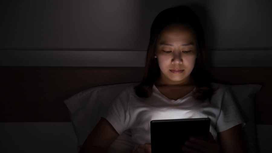 Lady in bed on a tablet