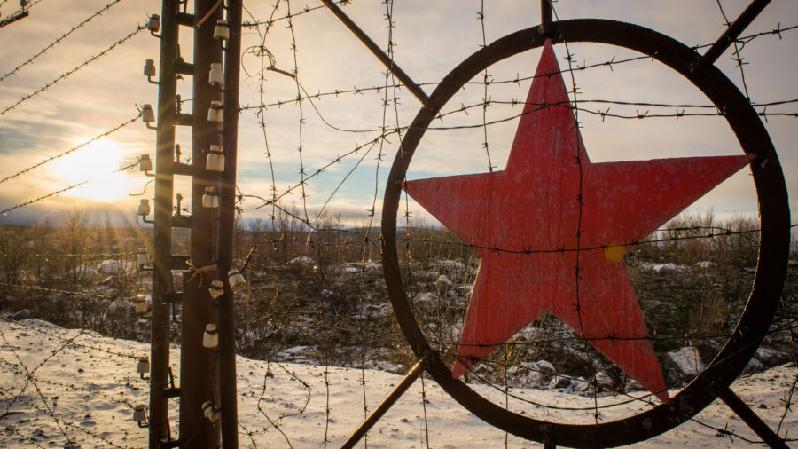 Rusty fence with Soviet Union symbol on it