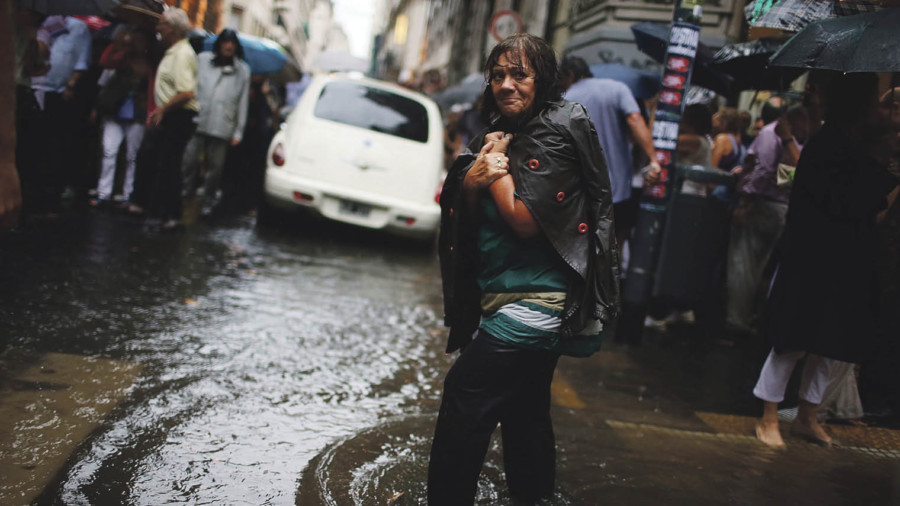Lady walking in flood water in a city