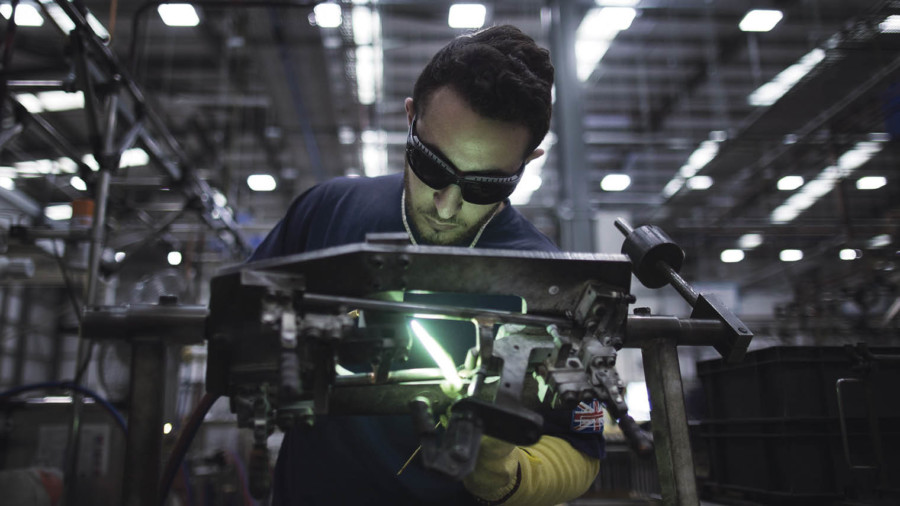 Employee welding parts at the Brompton Bicycle factory in London