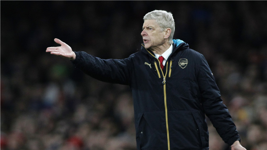 Arsene Wenger with arm raised at Arsenal match