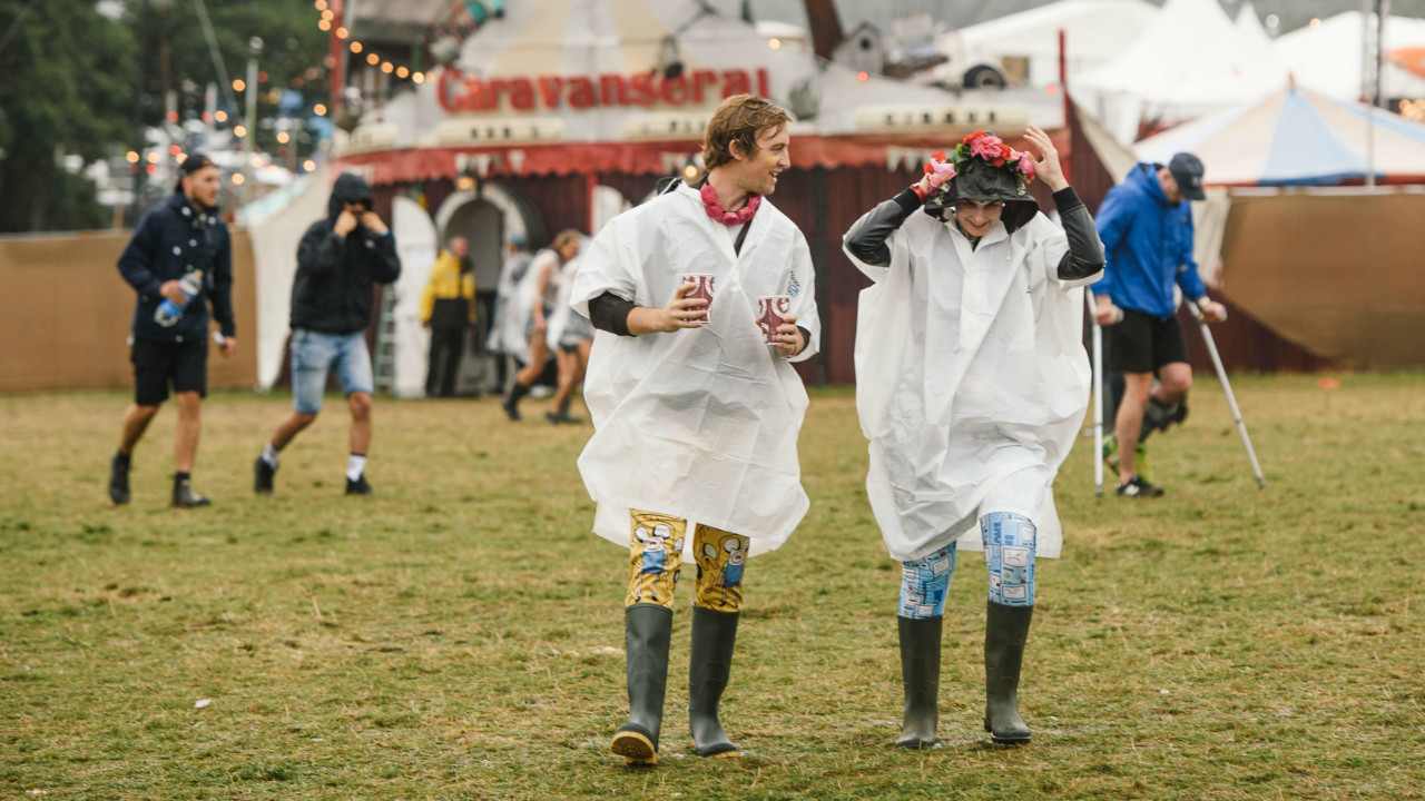 Two people at Bestival music festival dressed for rain