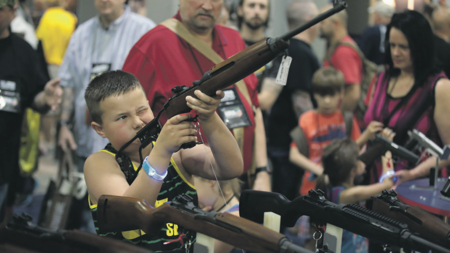 Young boy holding a rifle