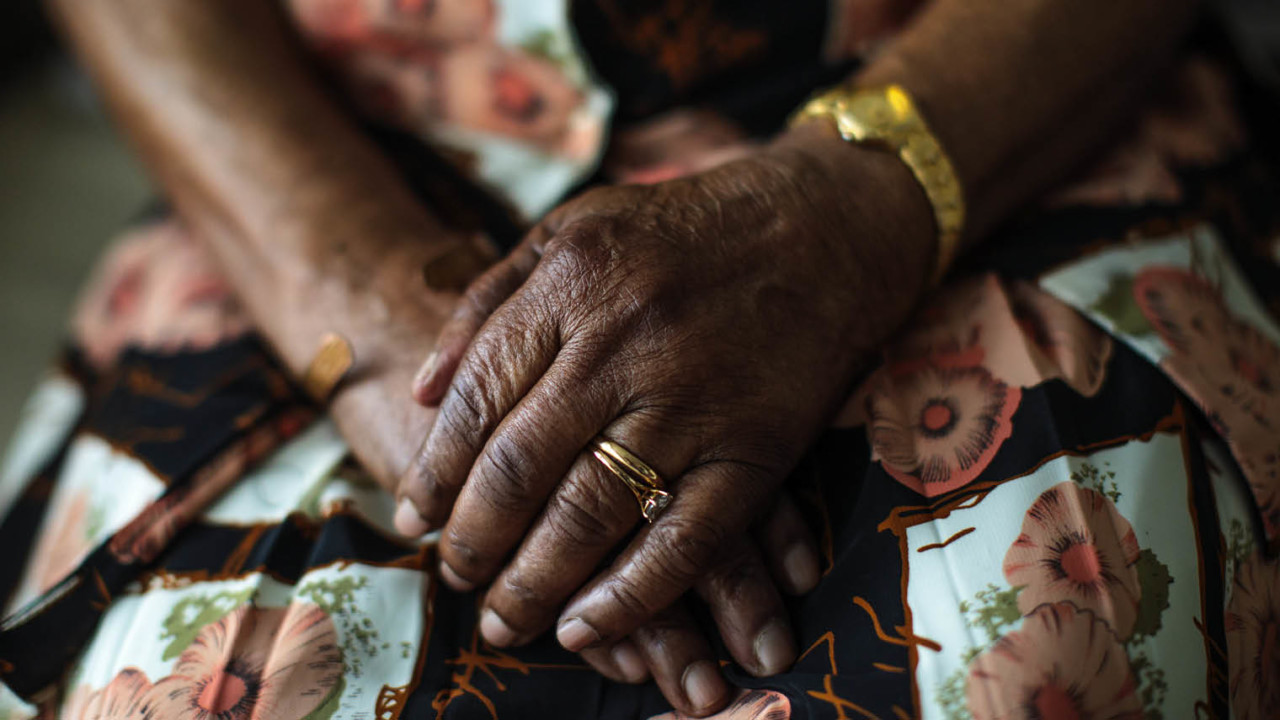 Elderly woman's hands in lap