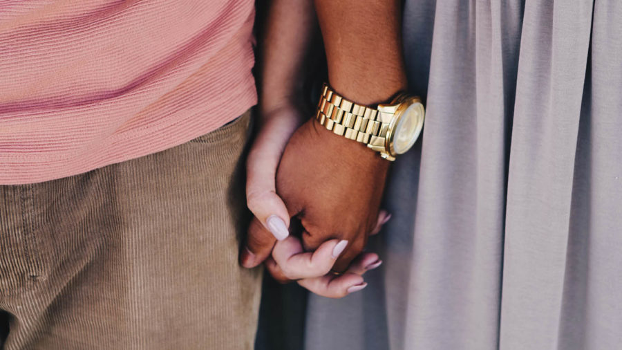 Close up couple holding hands