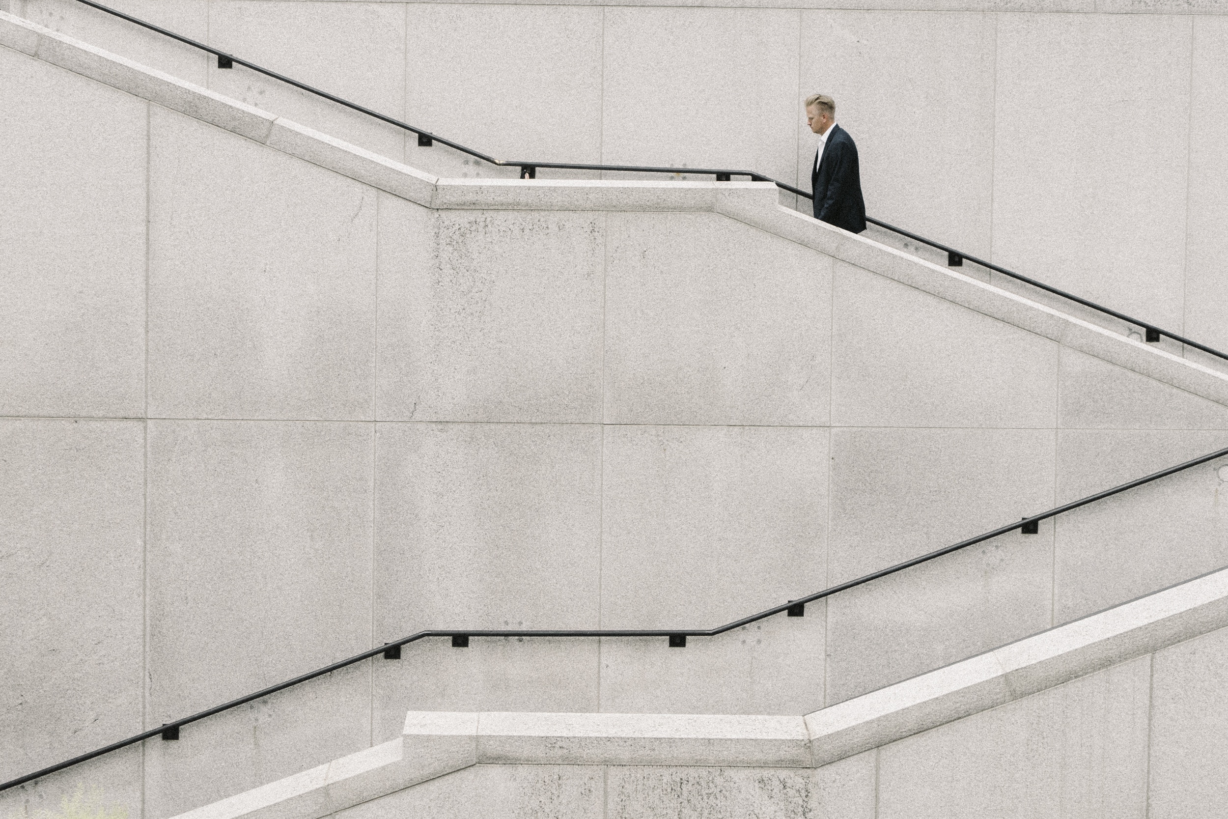 businessman walking up concrete stairs business growth 
