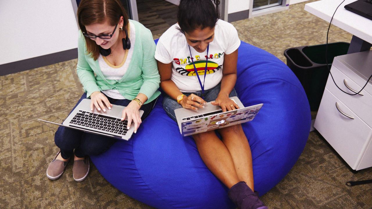 Women on beanbags with laptops diversity in tech