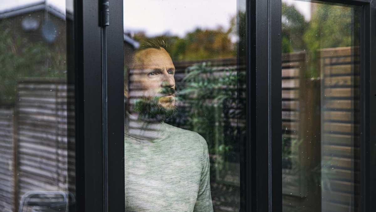 man looking out of a window