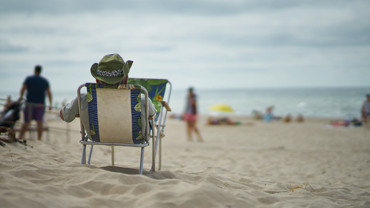 Man rests on beach in deckchair