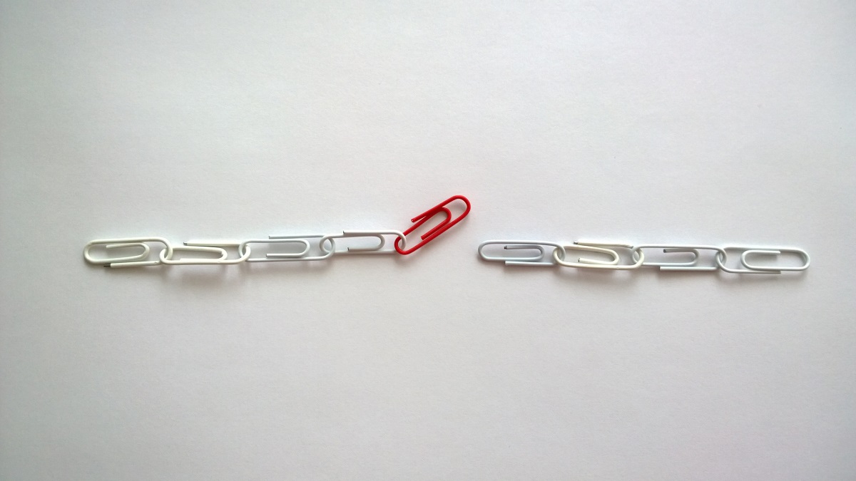 Chains Made From Red And White Paper Clips Against White Background