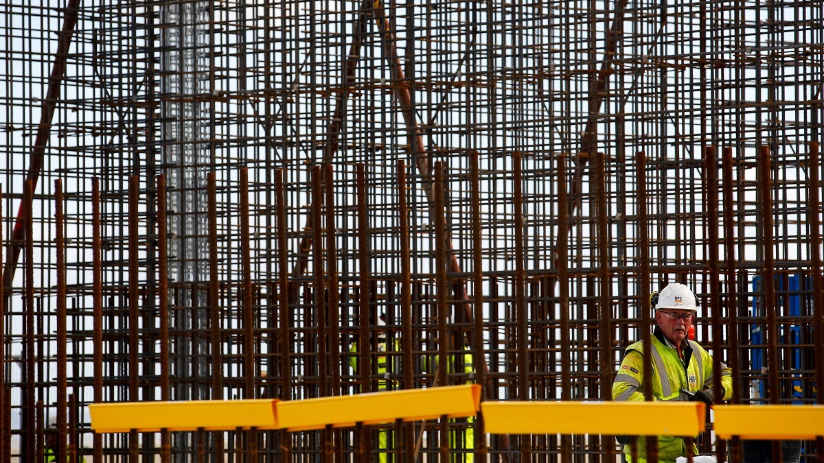 Man in hard hat by scaffolding