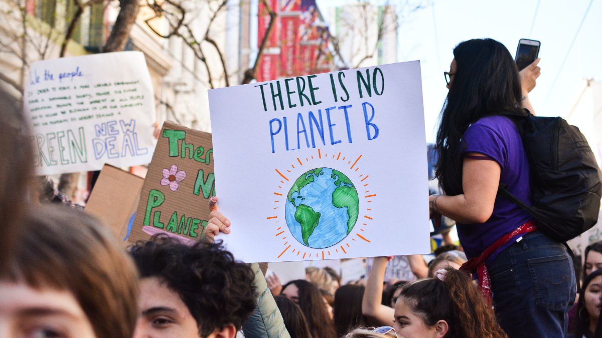 Climate activists hold up a sign saying 