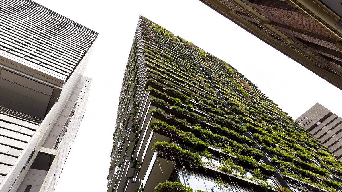 Low angle view of apartment building with vertical garden, sky background with copy space, Green wall-BioWall or living wall is a wall covered with living plants on residential tower, Sydney Australia, full frame horizontal composition