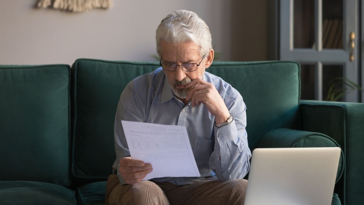 Older man looks through details of his financial assets