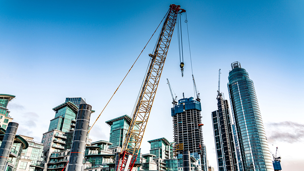 a crane amid tall buildings under construction