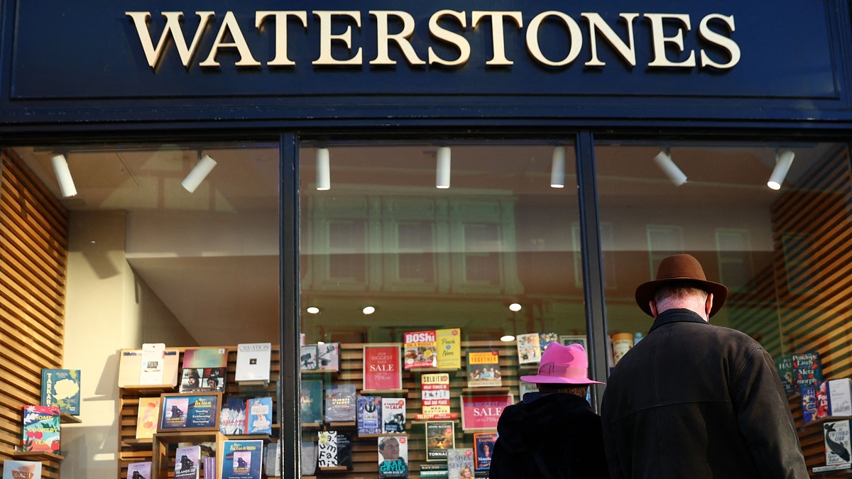 A couple look at books in the window display in a branch of Waterstones bookshop in Guildford, southwest of London on January 13, 2022. (Photo by Adrian DENNIS / AFP) (Photo by ADRIAN DENNIS/AFP via Getty Images)