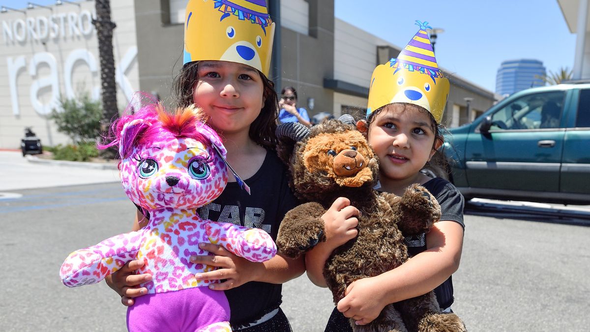 Two children take advantage of Build-A-Bear Workshop’s birthday promotion