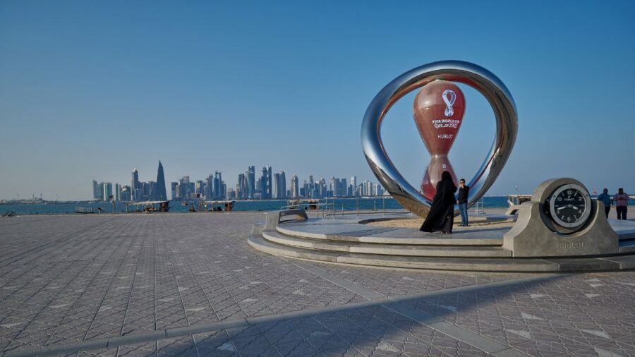 The FIFA World Cup Qatar 2022 Official Countdown Clock at Doha’s Corniche Fishing Spot with flags of participant countries