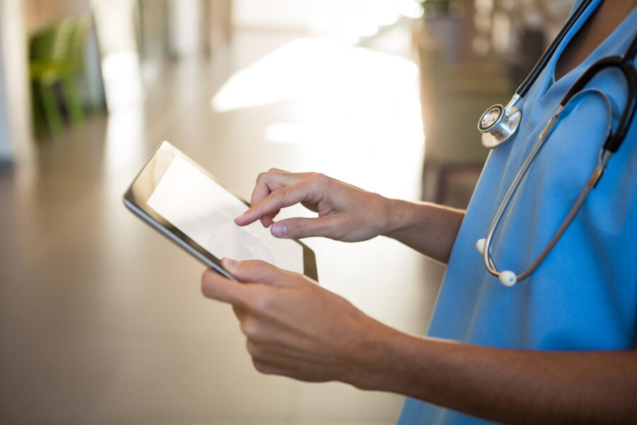 Doctor Using Digital Tablet In Hospital