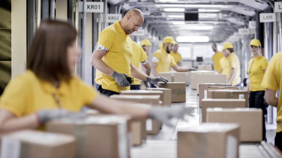 Workers in a warehouse working with cardboard boxes