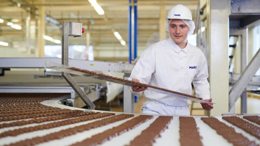 An employee of Mars working on the chocolate production line