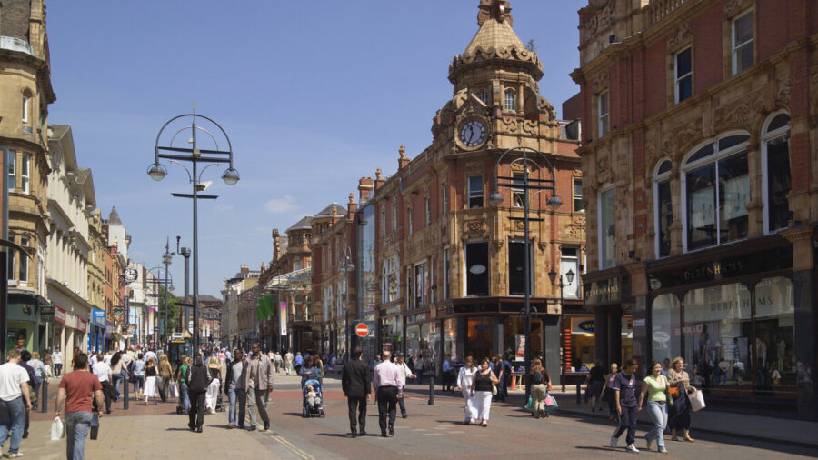 Shoppers walk through a pedestrianised high street in the UK