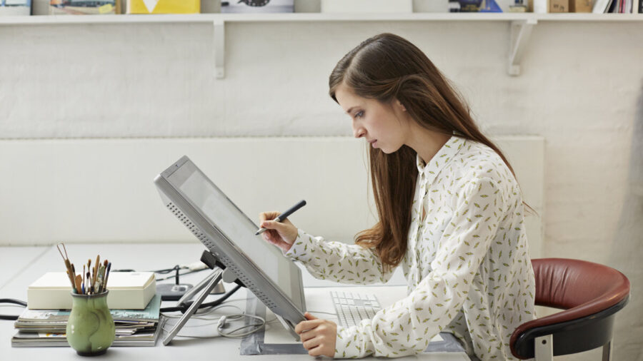 A young designer working on large tablet workstation