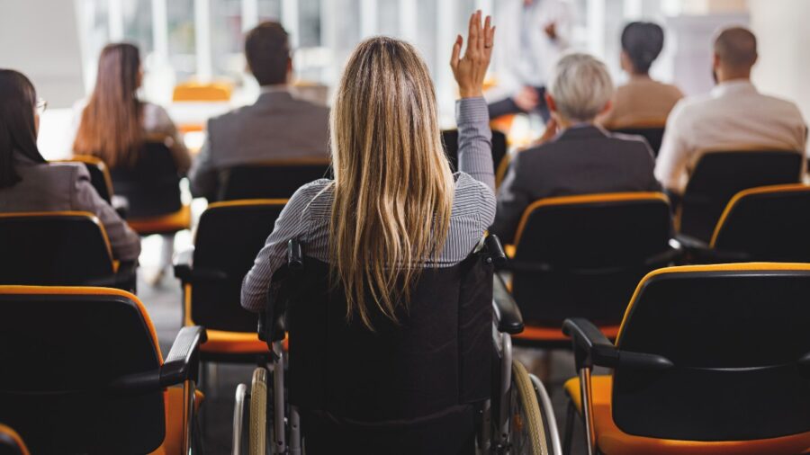 Woman in wheelchair at business event