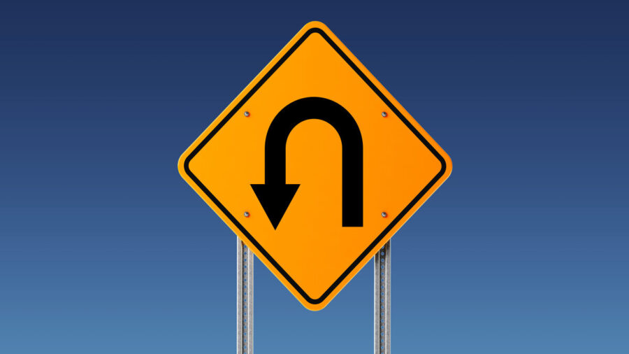 A yellow U-turn traffic sign, indicating a change in direction