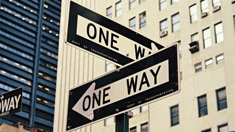 Road signs in New York saying ONE WAY illustrating decision-making