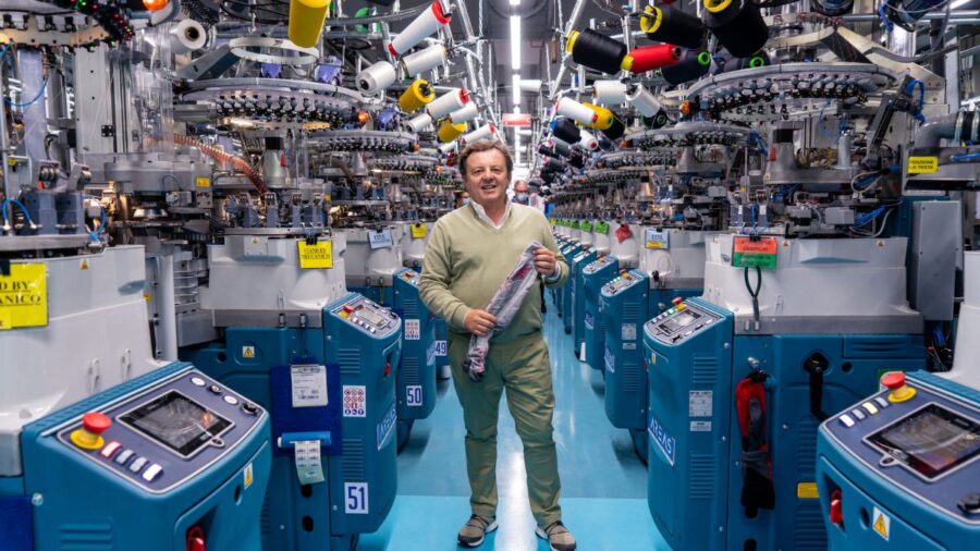 Marco Redini brandishing a pair of UYN socks in its Asola factory